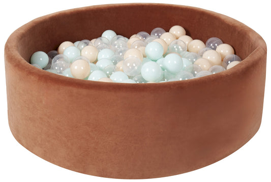 Brown basin filled with colorful balls on a white background
