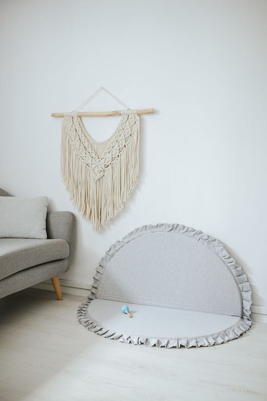 Crushed light-grey velvet play mat for babies, no toddlers playing.