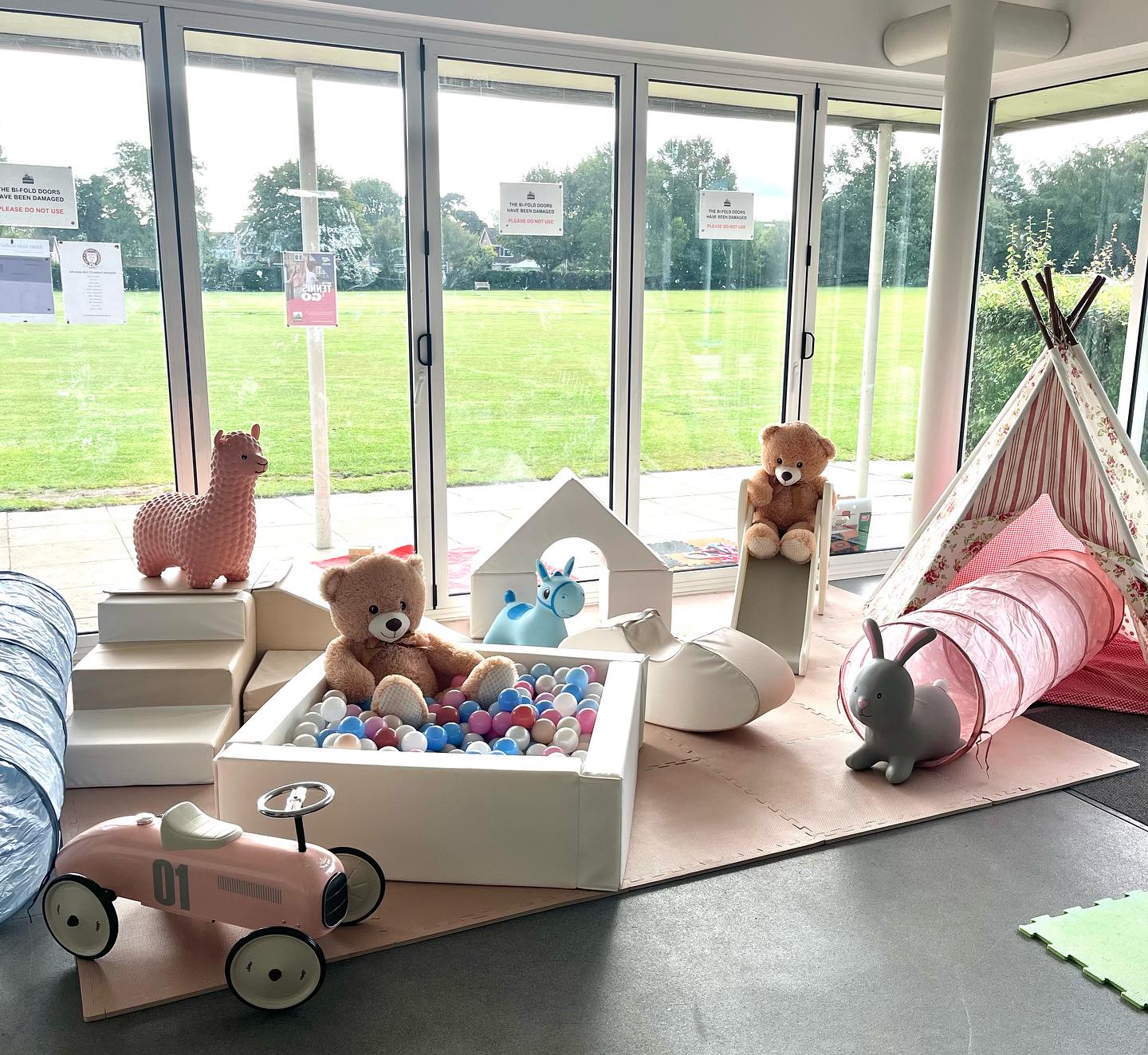 Mixed soft play sets and toys with bears, a bouncer, and a car.