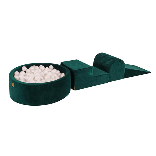 A dark green velvet ball pit with a set of white balls, accompanied by a removable cover and a soft play set.