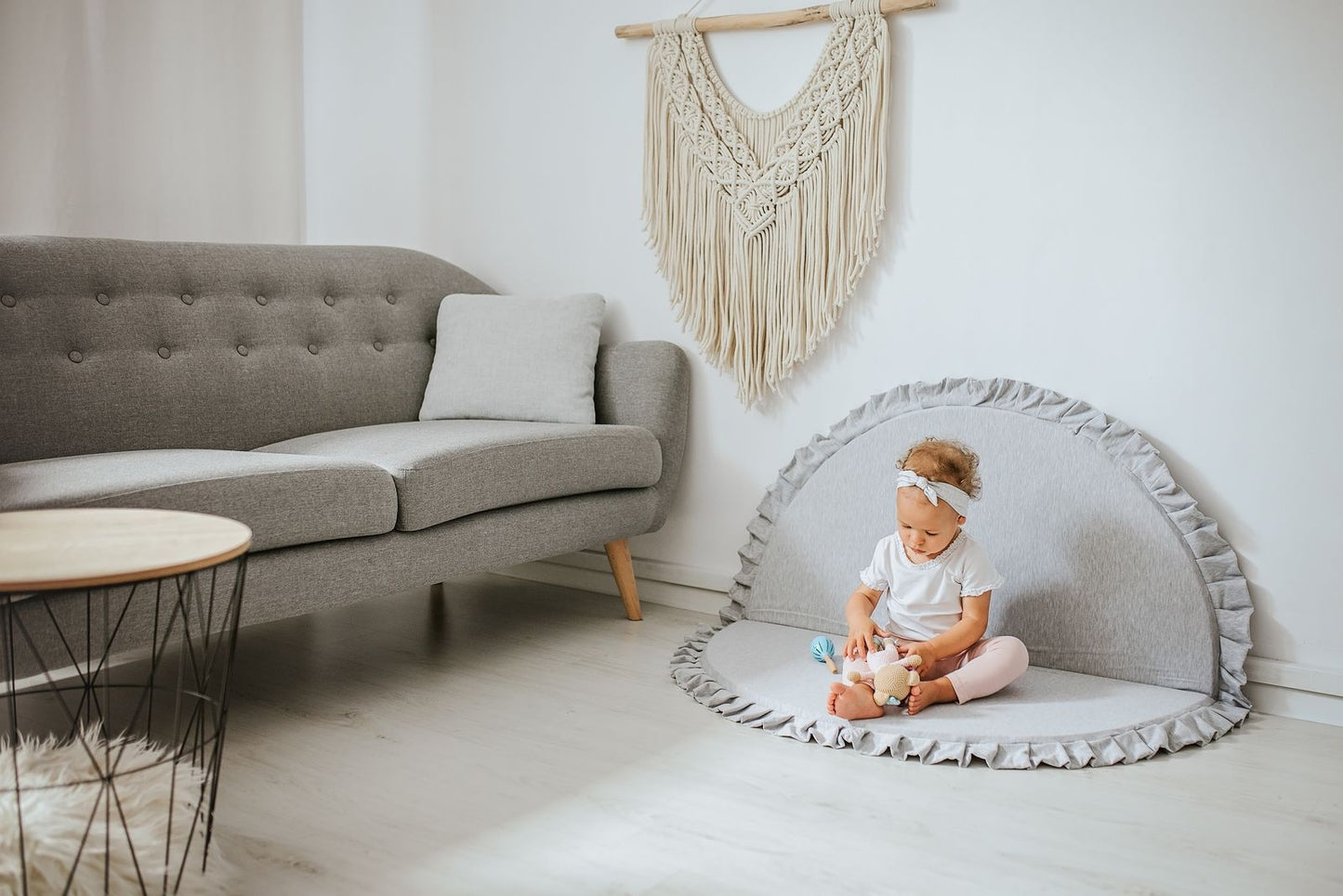 Crushed light-grey velvet play mat for babies, with a toddler playing