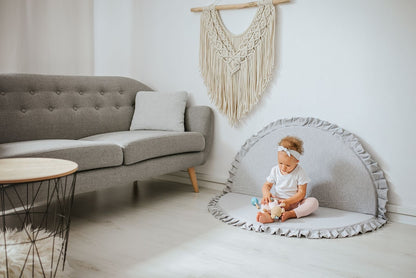 Crushed light-grey velvet play mat for babies, with a toddler playing