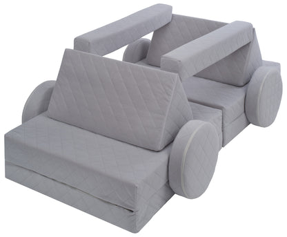 Side-view of light grey soft play sofa.